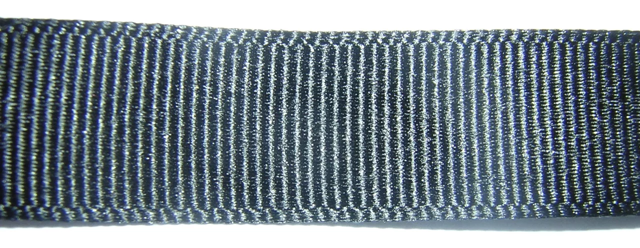 Macro close-up of a dark navy woven ribbon, close crosswise ribs running from edge to edge.